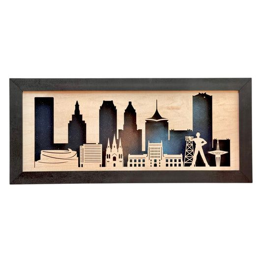 Laser-cut wood wall art of the Tulsa skyline with iconic buildings and the Golden Driller silhouette on a starry night background
