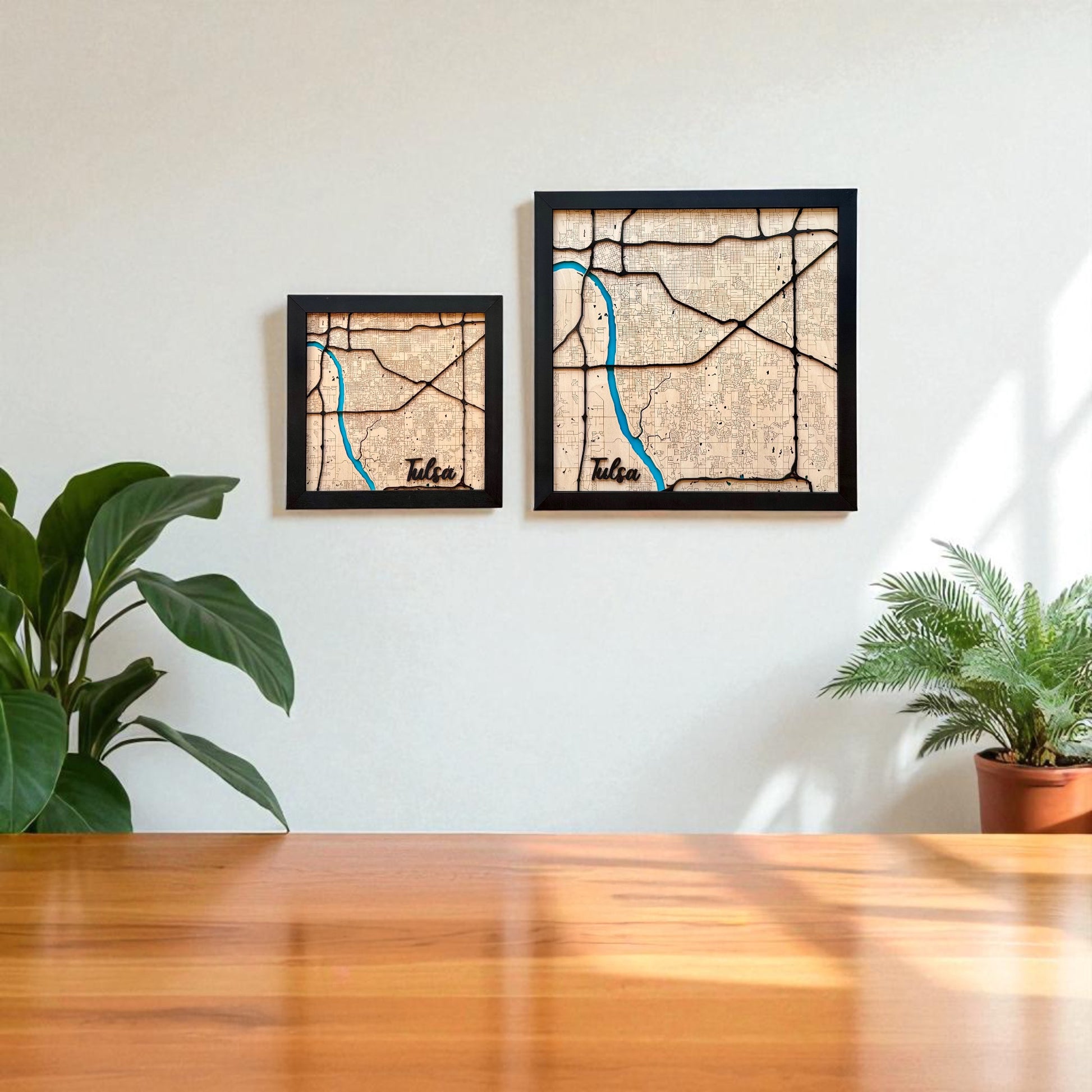 Two framed Tulsa wooden city maps in different sizes hanging on a wall, layered laser cut wood maps used as local Tulsa decor