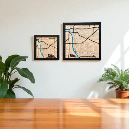Two framed Tulsa wooden city maps in different sizes hanging on a wall, layered laser cut wood maps used as local Tulsa decor
