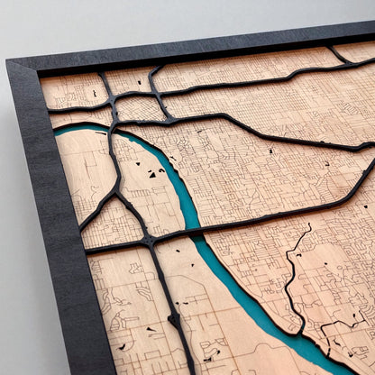 Close up of painted blue river on Tulsa wooden city map, layered wood design showing river and surrounding streets