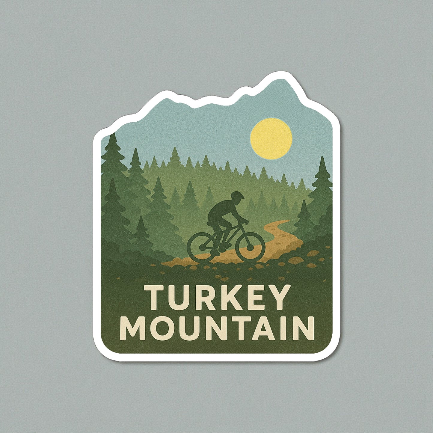 Die cut Turkey Mountain Tulsa sticker displayed on a neutral wall surface, forest and mountain biking artwork representing Tulsa outdoor trails
