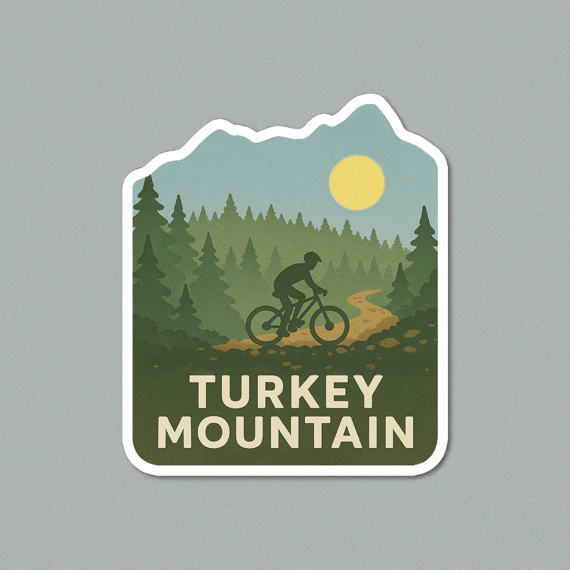 Die cut Turkey Mountain Tulsa sticker displayed on a neutral wall surface, forest and mountain biking artwork representing Tulsa outdoor trails