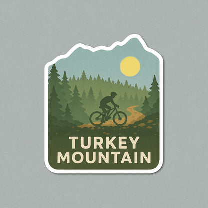 Die cut Turkey Mountain Tulsa sticker displayed on a neutral wall surface, forest and mountain biking artwork representing Tulsa outdoor trails