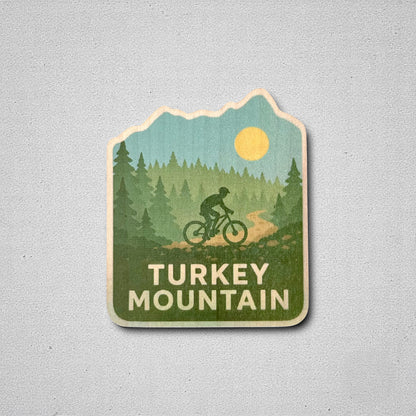 Turkey Mountain wood sticker displayed on a neutral background, showcasing vibrant trees, a cyclist, and Oklahoma trail vibes—great for indoor decor or laptops.
