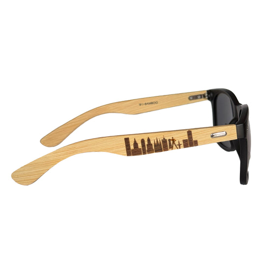 Side view of black matte frame sunglasses with bamboo arms laser engraved with the Tulsa skyline