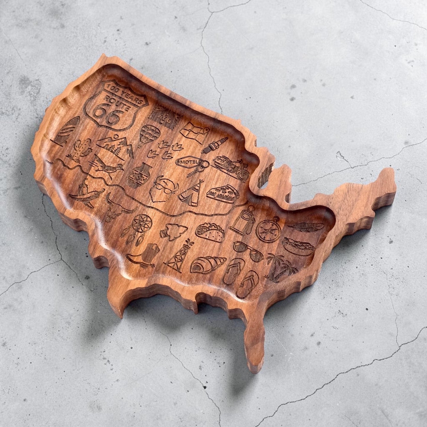 Side perspective of engraved wooden USA catch all tray showing carved recessed interior and detailed Americana travel artwork inspired by Route 66 road trips across America