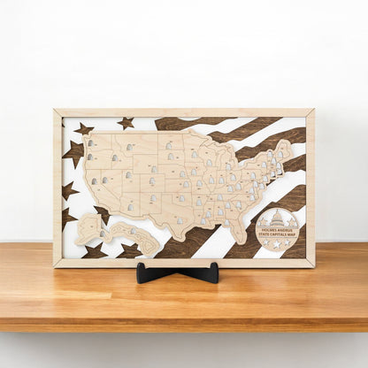 Wooden USA state capitals travel map displayed on a shelf showing layered wood construction