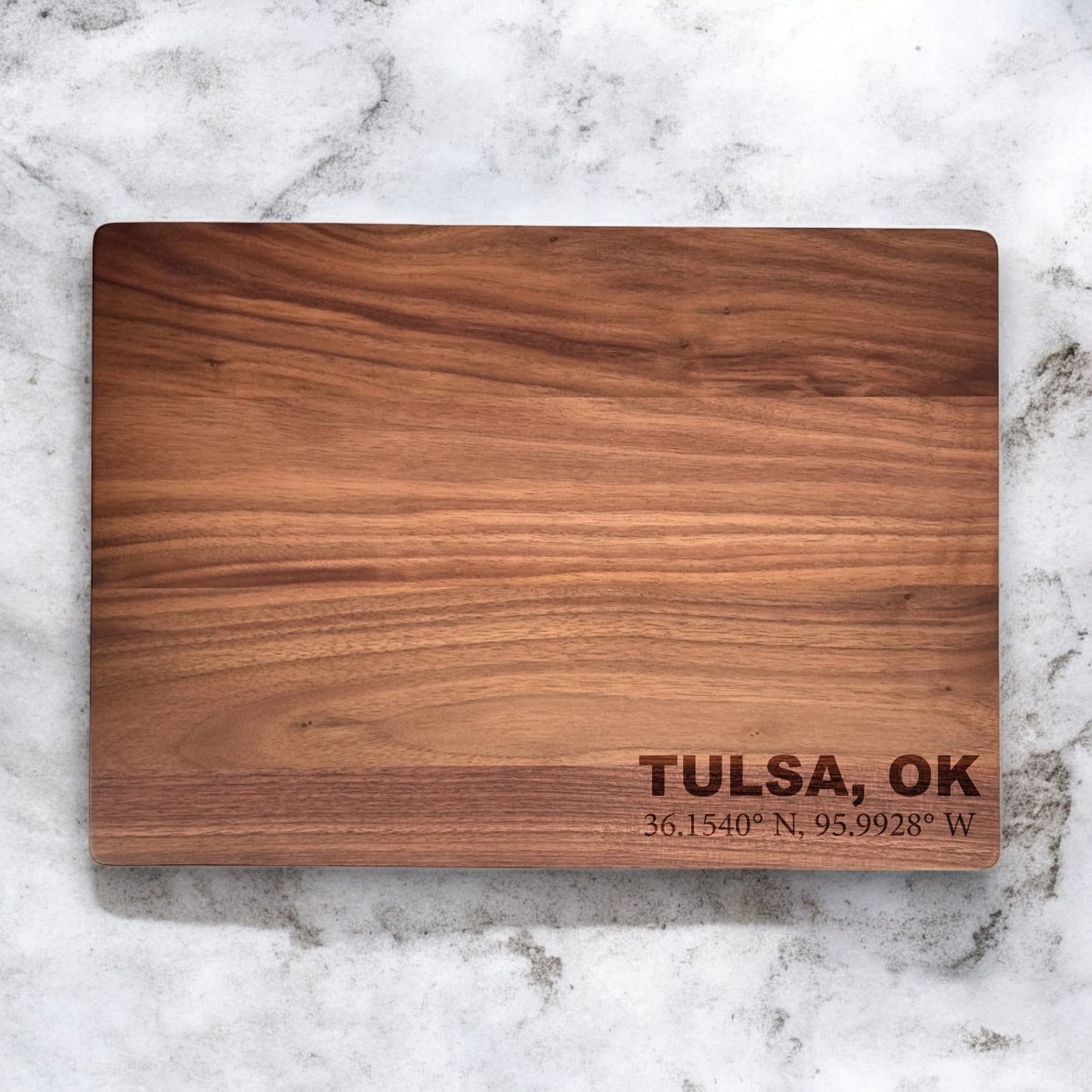Solid walnut cutting board with custom engraved text, smooth food safe finish and natural dark wood grain
