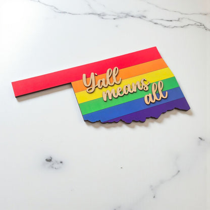 Angled view of Oklahoma rainbow wooden sign with layered construction and natural wood lettering