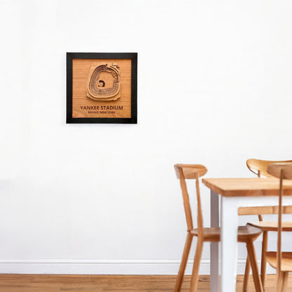 Yankee Stadium wooden wall art displayed on a white wall above a dining table and chairs