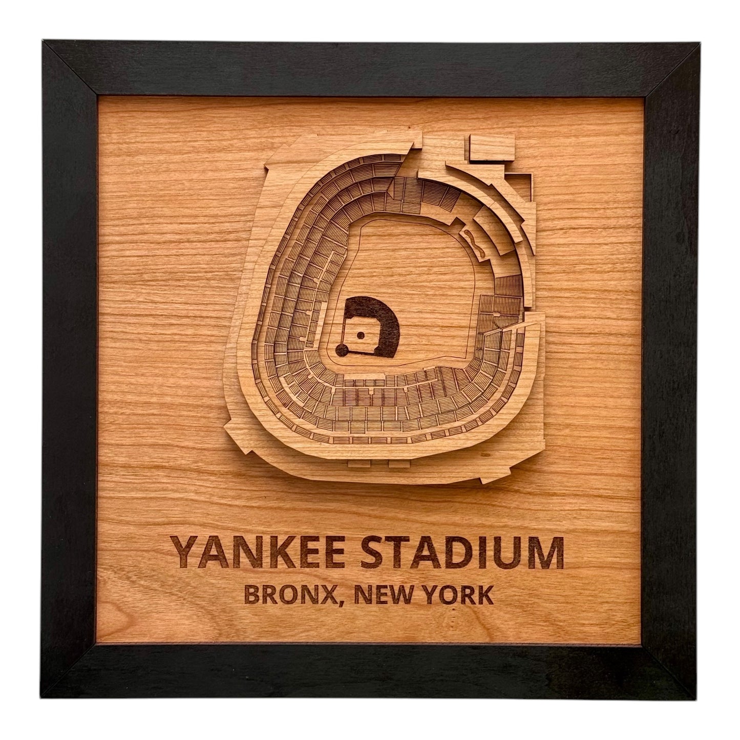 Framed wooden wall art showing a top down view of Yankee Stadium with engraved stadium name and Bronx New York location